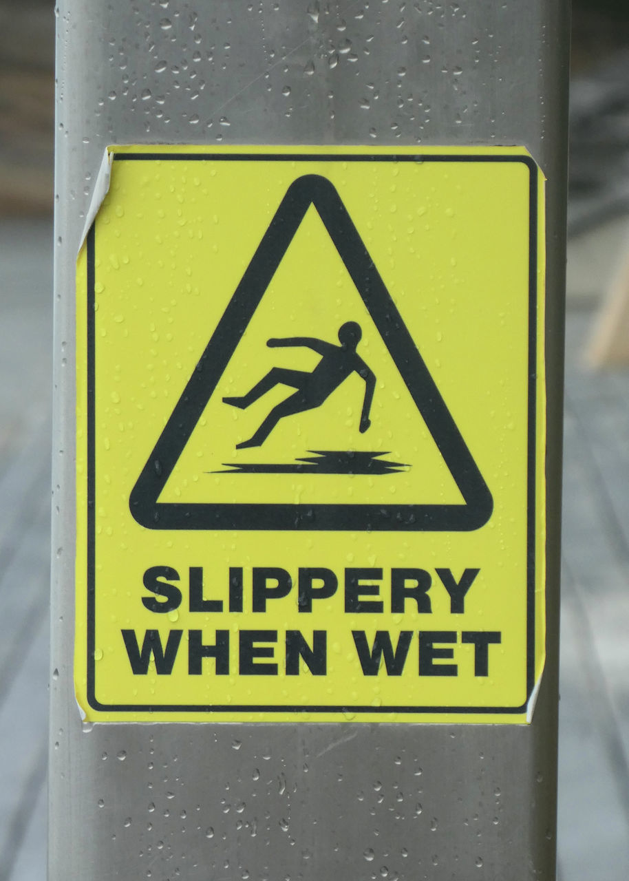 CLOSE-UP OF ARROW SIGN