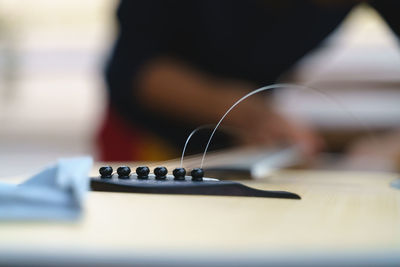 Close-up of guitar on table