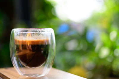 Close-up of coffee in glass on table