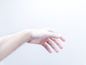 Close-up of hands over white background