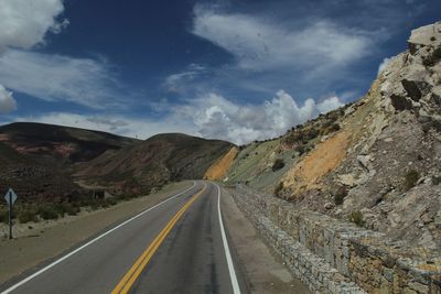 Road amidst mountains against sky