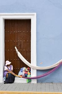 Woman sitting outside building
