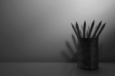 Close-up of pencils in container on table