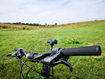 Bicycle on field against sky