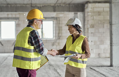 Engineers shaking hands at construction site