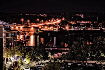 Illuminated city against sky at night