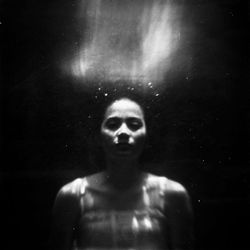 Portrait of woman in darkroom