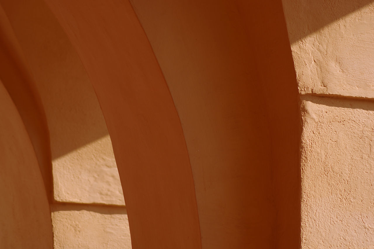 FULL FRAME SHOT OF WALL WITH SHADOW OF BUILDING