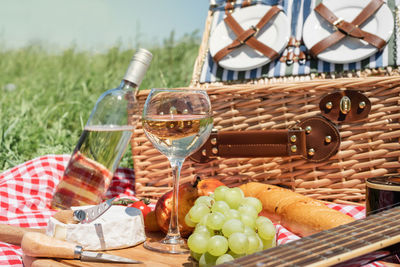 Closeup of picnic basket with drinks and food on the grass. nice picnic on sunny summer day, 