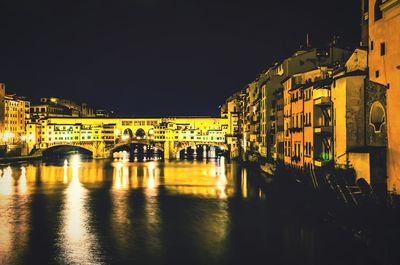 Illuminated city against clear sky at night