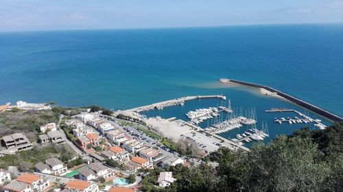High angle view of sea and cityscape against sky