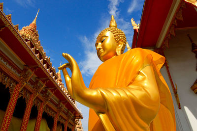 Low angle view of statue against temple building