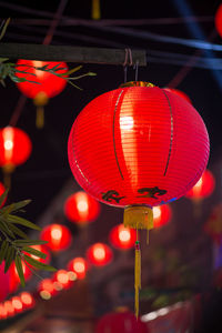 Close-up of illuminated lanterns hanging at night