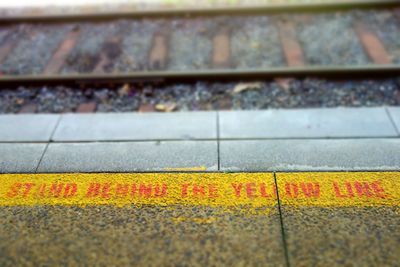High angle view of text on railroad station platform