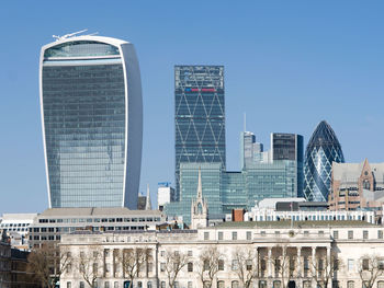 Low angle view of modern building against blue sky