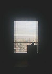 Silhouette building seen through window