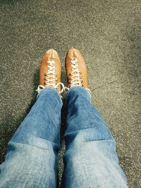 Low section of man wearing shoes standing outdoors