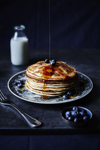 Close-up of maple syrup poured on pancakes