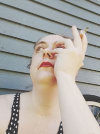 Close-up of woman hand against wall