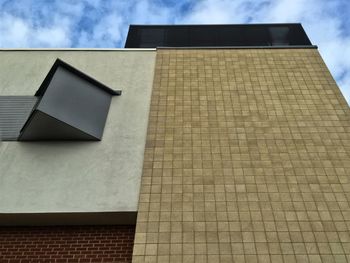 Low angle view of building against cloudy sky