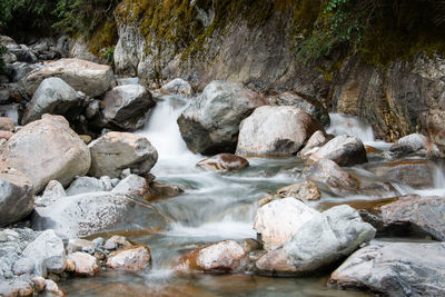 Stream flowing through rocks in forest