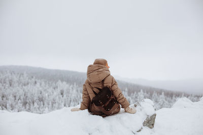 Portrait of a young girl traveler in the snowy mountains