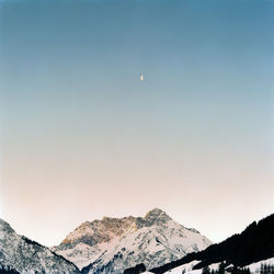 Scenic view of snowcapped mountains against clear sky