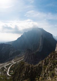 Low angle view of rock formation against cloudy sky