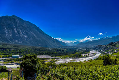 Scenic view of mountains against blue sky