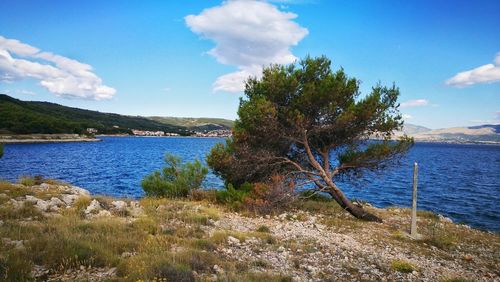 Scenic view of river and mountains against sky
