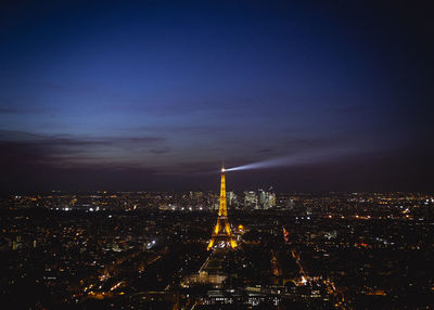 Aerial view of city lit up at night