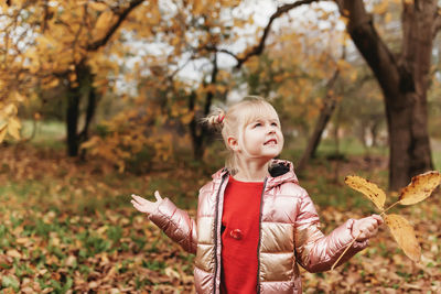 Girl standing on leaves during autumn