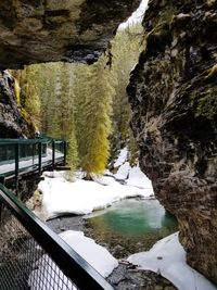 Scenic view of river amidst snow covered mountains