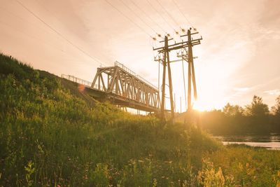 Bridge over field against sky