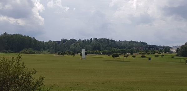 Panoramic view of trees on field against sky