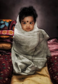 Portrait of cute girl lying on bed at home