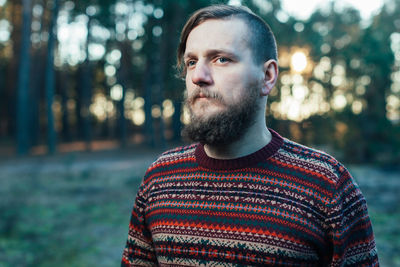 Close-up of thoughtful man in forest