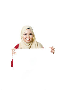 Portrait of a smiling young woman over white background