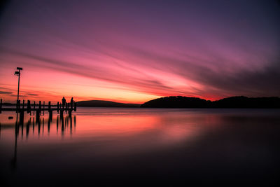 Reflection of clouds in lake at sunset