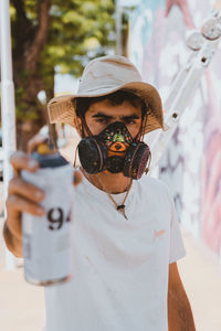 Portrait of young man wearing sunglasses standing outdoors