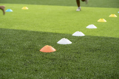 Low section of people playing soccer on field