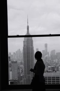 Rear view of silhouette man and woman standing in city