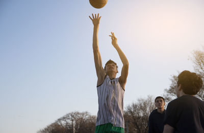 Teenager group playing street baskteball