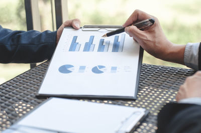 Close-up of business colleagues working in office