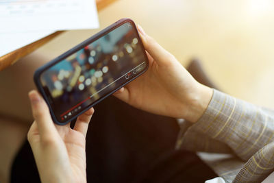 Midsection of man using mobile phone