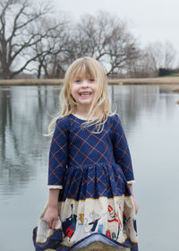 Portrait of smiling girl standing in lake