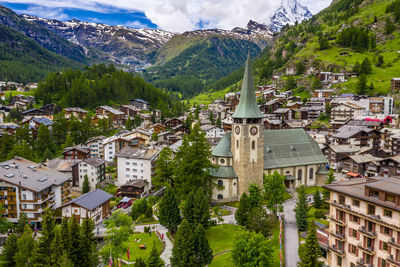 Buildings in town against mountains