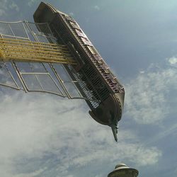 Low angle view of building against cloudy sky