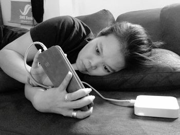 Portrait of young woman lying on floor