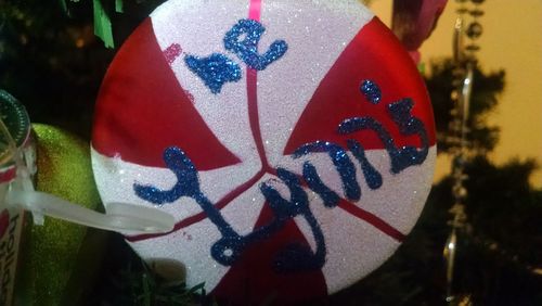 Close-up of red decoration on white wall
